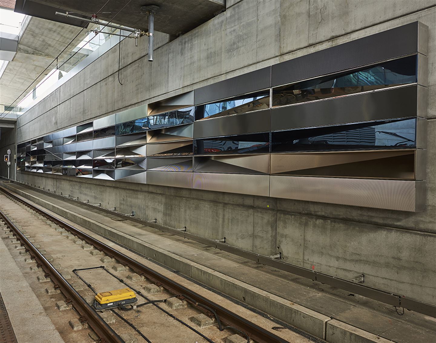 foto av kunstverket Modulære refleksjoner på bybanestoppet på Flesland. Det er vegg av speglar i ulike vinklar.